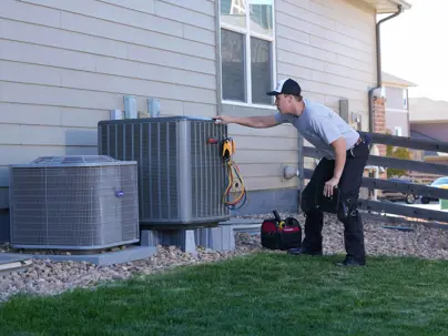 technician performing air conditioner maintenance